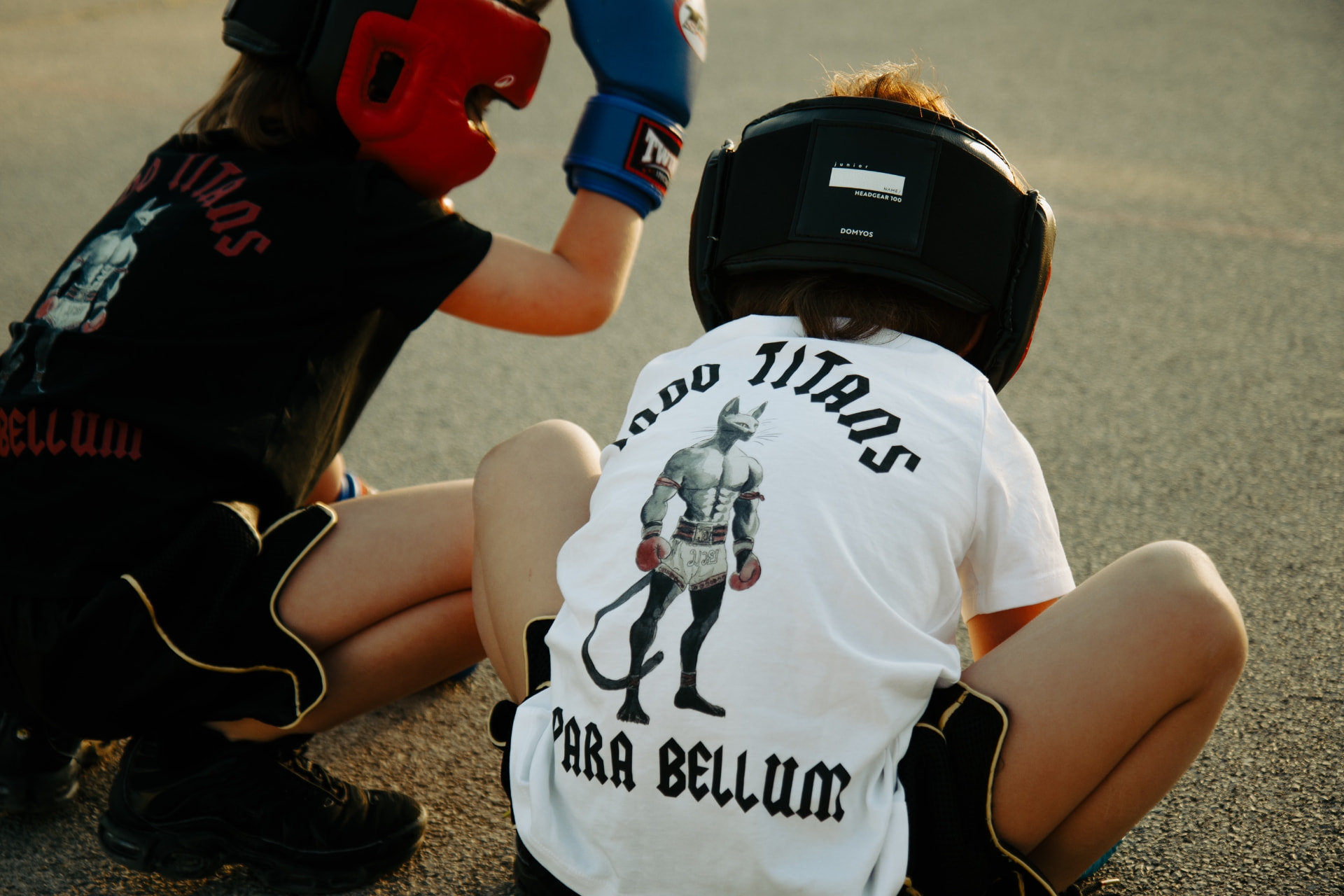 Two young boxers wearing INDOTITANS PARA BELLUM tees
